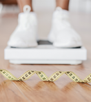 closeup-black-woman-standing-on-scales-focus-on-m-2022-12-16-07-13-49-utc